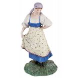 A RUSSIAN PORCELAIN FIGURE OF A DANCING PEASANT WOMAN, POPOV PORCELAIN FACTORY, MID-19TH CENTURY