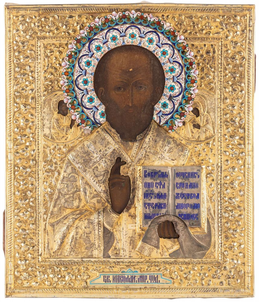 A RUSSIAN ICON OF ST. NICHOLAS THE WONDERWORKER WITH GILT SILVER AND SHADED ENAMEL OKLAD, 1908-1917