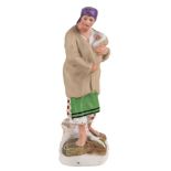 A RUSSIAN PORCELAIN FIGURE OF A PEASANT WOMAN WITH A CHILD DMITROVSKAYA PORCELAIN VERBILKI 1920s-40s