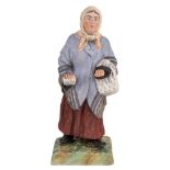 A RUSSIAN PORCELAIN FIGURE OF A JEWESS, GARDNER PORCELAIN FACTORY, MOSCOW, LATE 19TH CENTURY