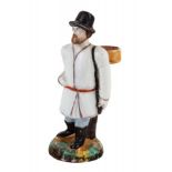 A RUSSIAN PORCELAIN FIGURE OF A TRAVELER WITH A BASKET OF BERRIES, PRIVATE PORCELAIN FACTORY