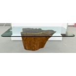 A CONTEMPORARY GLASS-TOP TABLE WITH WOODEN BASE