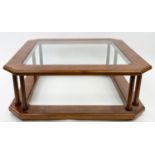 A CONTEMPORARY WOODEN COFFEE TABLE WITH GLASS TOP