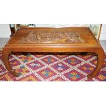 The profusely carved rectangular shaped top, raised on scroll legs