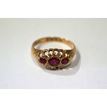 9 CT. GOLD AND RUBY THREE STONE RING
