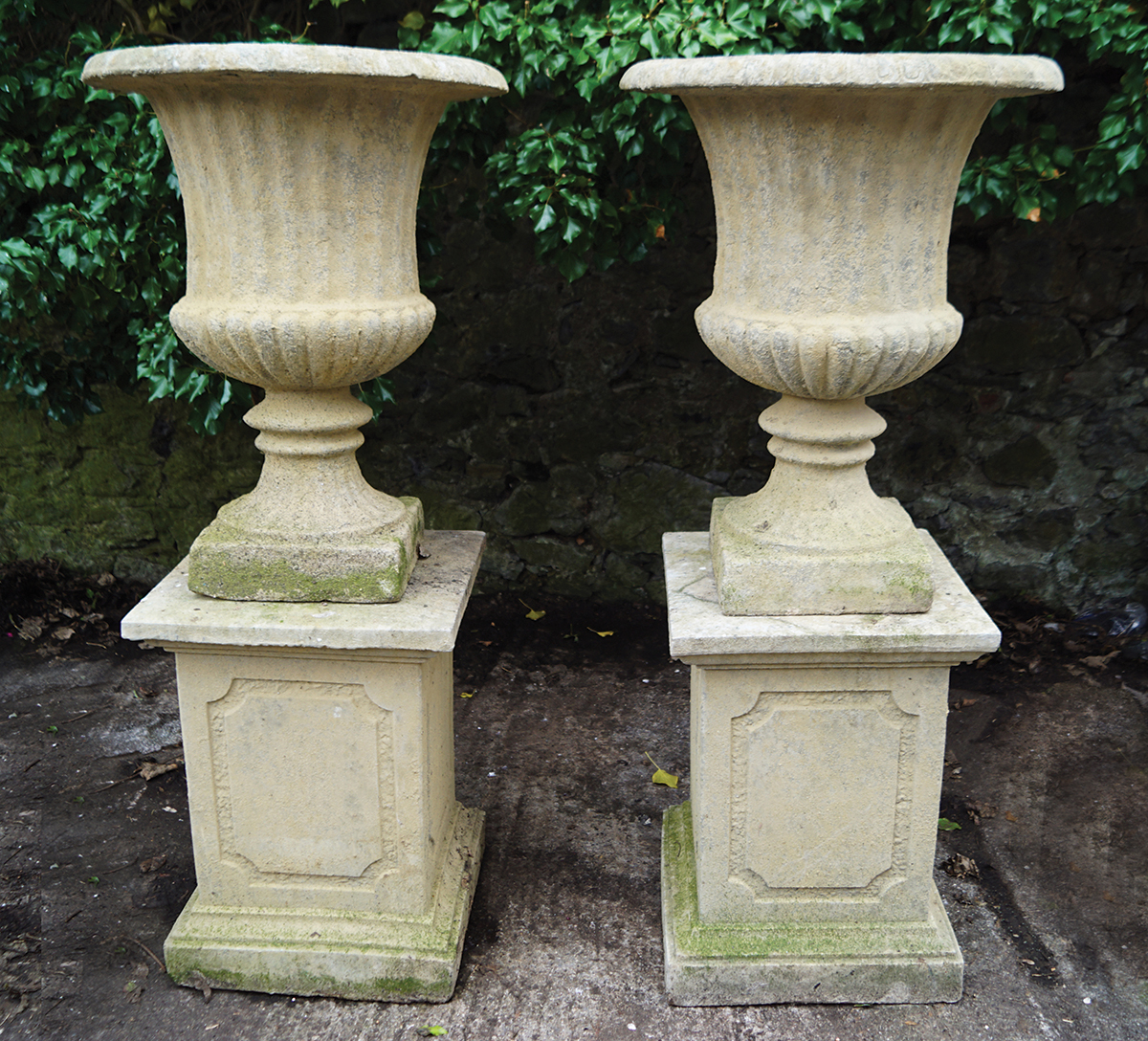 PAIR OF ITALIANATE STONE URNS