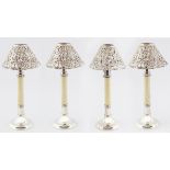 FOUR EDWARDIAN SILVER-PLATED CANDLE HOLDERS