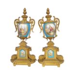 PAIR OF GILT METAL AND SEVRES PORCELAIN URNS