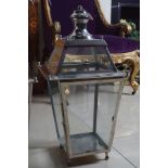 THREE POLISHED METAL CANDLE LANTERNS 58 cm. high; 30 cm. square