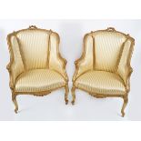 PAIR OF GILT FRAMED WING BACKED ARMCHAIRS