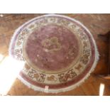 Circular Chinese pink ground dragon motif rug (50" diameter)