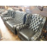Green leather buttoned studded wingback sofa and pair armchairs