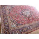 Red ground Persian floral design carpet (135" x 94")