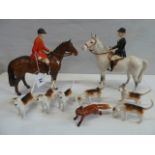 Beswick huntsman on brown horse, huntswoman on grey horse,