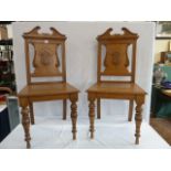 Pair honey oak shield back hall chairs