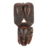 MaskeElfenbeinküste, Holz, schwarz-rotbraun-weiß eingefärbt, mit maskenverzierter