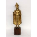 STEHENDER BUDDHAThailand, 20.Jh. Bronze, vergoldet. H.51cm. Holzsockel.A STANDING BUDDHA Thailand,