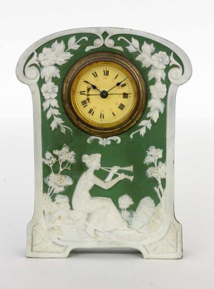 A PHANOLITH BRACKET CLOCK WITH ALARM circa 1900 Stoneware with green background and whiterelief