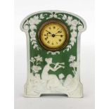A PHANOLITH BRACKET CLOCK WITH ALARM circa 1900 Stoneware with green background and whiterelief
