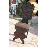 A CHAIR 19th century Ebonized wood with relief carvings.BRETTSTUHL19.Jh. Ebonisiertes Holz mit