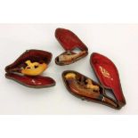 THREE OLD MEERSCHAUM PIPES with leather cases. 7-11.5 cm long. Condition: signs of wear and tear