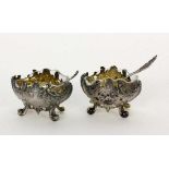 A PAIR OF SALT BOWLS France, 19th century Baroque style. Silver with gilt interior,original glass