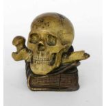 A PAPERWEIGHT WITH SKULL 1st half of 20th century Skull with bones on a book. Terracotta,painted. 11