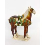 A HORSE IN TANG STYLE China. Ceramic figurine glazed in Sancai colours. 27.5 cm highPFERD IM TANG-