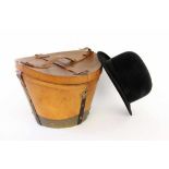 A HATBOX circa 1900 Brown leather, metal fittings, lock. (Key missing). Includes an oldbowler hat of