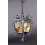 A GARDEN LANTERN Wrought-iron frame with coloured glass panels. 67 cm high. Condition: oneglass