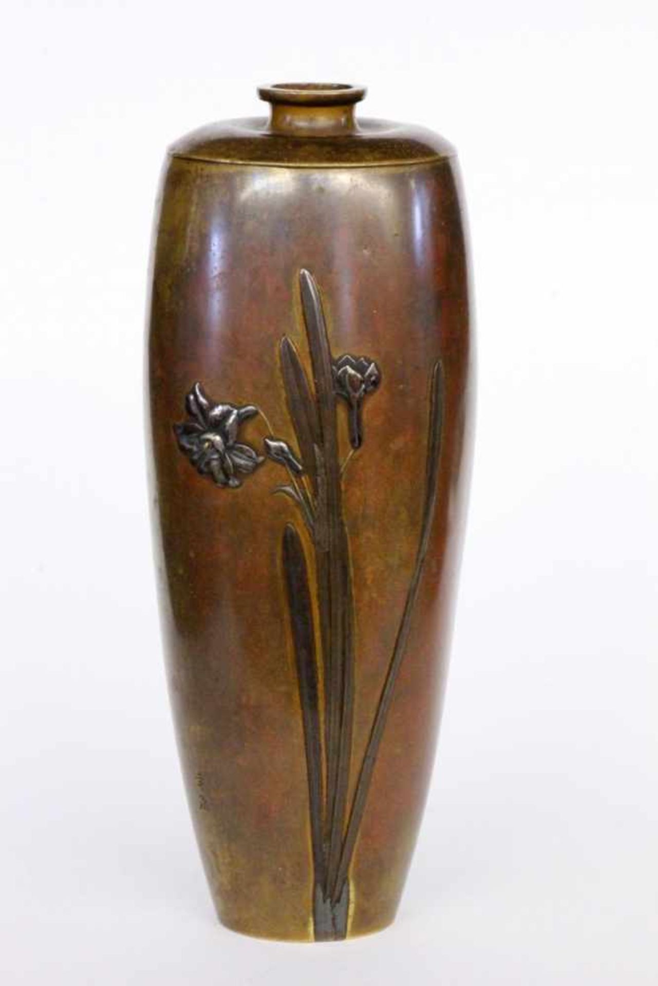 A VASE Japan. Meiji period Bronze with lily decoration in relief. Seal mark: Inoue. 22.5cm high.