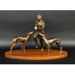 AN ART DECO GROUP OF FIGURES France, 20th century Woman with ivory ball and 2 greyhounds.Patinated
