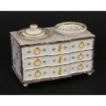 AN INKWELL IN THE FORM OF A COMMODE France, 20th century Faience with coloured painting.Maker's
