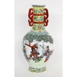 A PORCELAIN VASE China Baluster form with surrounding dance portrayals in the FamilleVerte style.