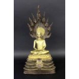 A BUDDHA WITH 7 NAKA DRAGON HEADS Northern Thailand 2 pieces, gilt bronze. 42 cm highBUDDHA MIT 7