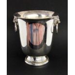 A CHAMPAGNE COOLER Silver-plated metal. Krater-shaped with lions' heads as handles.Marked: