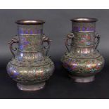 A PAIR OF HANDLED CLOISONNE VASES probably Japan, Meiji period. Bronze with reliefdecoration and