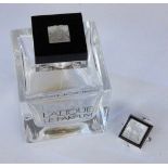 A LALIQUE BOTTLE AND PENDANT ''Lalique Le Parfum'' and pendant with silver mount.LALIQUE FLAKON