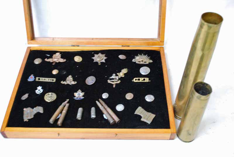 Cased display of British military badges, buttons etc including King's Regiment, Cheshire Regiment