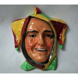 A Royal Doulton Wall Mask, Jester in yellow and green and red glazes, black factory mark, incised