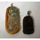 An Oriental carved Jade Pendant, decorated in relief with mythical creatures, rounded rectangular