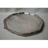 A mid 20th century silver three-footed Tray of shaped circular form supported on scroll feet,