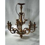 A late 19th/early 20th century cast and gilt brass six light Chandelier, the sconces as flowers