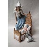 A large Lladro Figural Group modelled as a young woman and a dog watching a baby in a cot, 30cm high