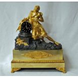 An imposing French Empire style sculptural Mantel Clock, cast bronze and mercury gilded featuring