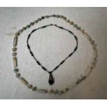 A white jade Necklace with green graduations of tube and ball form on white metal wirework links
