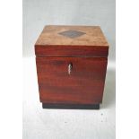 A mahogany and walnut Tea Caddy of cube form, the inlaid hinged cover opens to reveal an inlaid