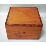 A yew wood Trinket Box of square form, the crossbanded domed lid opens to reveal a removable tray