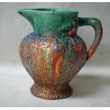 A Clarice Cliff Delicia Jug, dribble glazed in multicolours on beaded texture body, printed mark