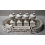 An eight piece creamware Table suite comprising a set of four short pierced urnular bud vases on